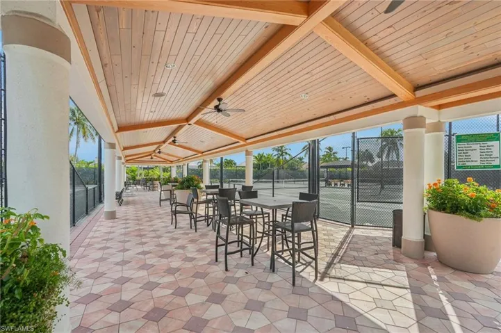 View of patio with ceiling fan and outdoor dining area