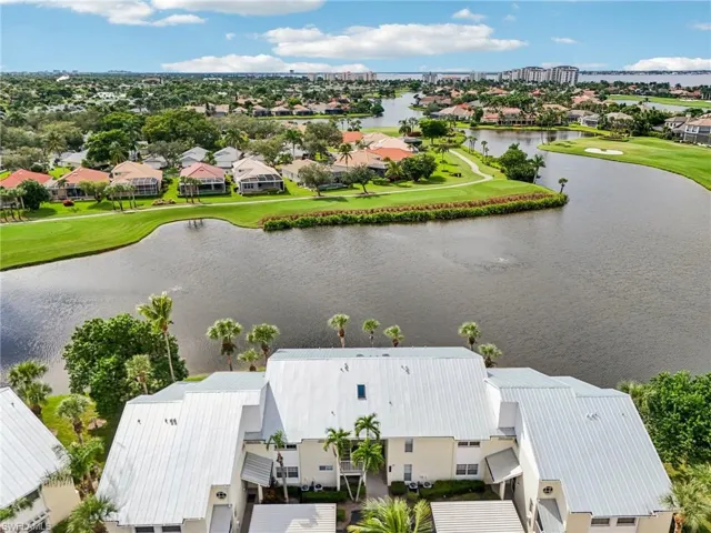 Aerial perspective of suburban area with a local golf course and a large body of water