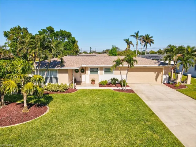 Single story home with a front yard and a garage