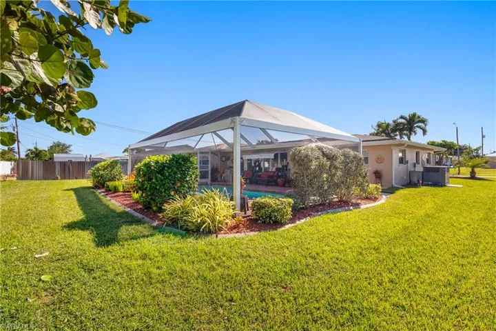 Back of house with screened lanai and pool