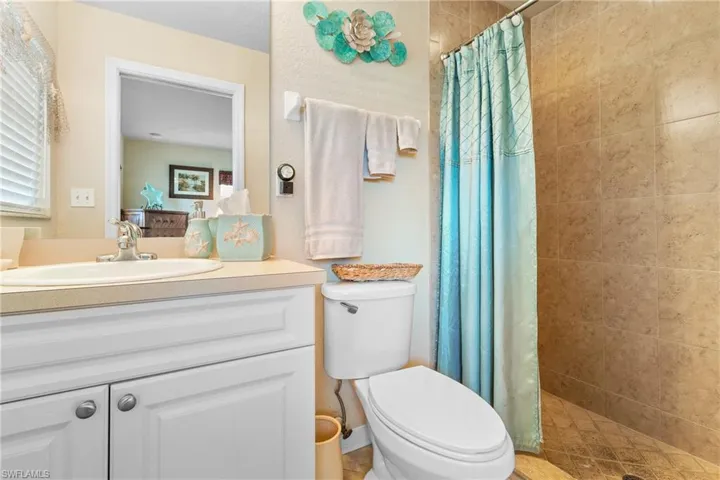 Master Bathroom featuring walk in shower, vanity, and toilet