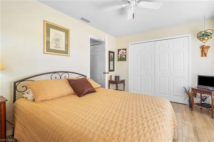 Guest Bedroom with a closet, light hardwood / wood-style flooring, and ceiling fan