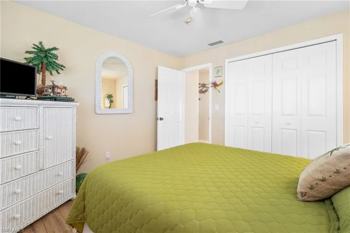 Guest Bedroom with wood-type flooring, a closet, and ceiling fan