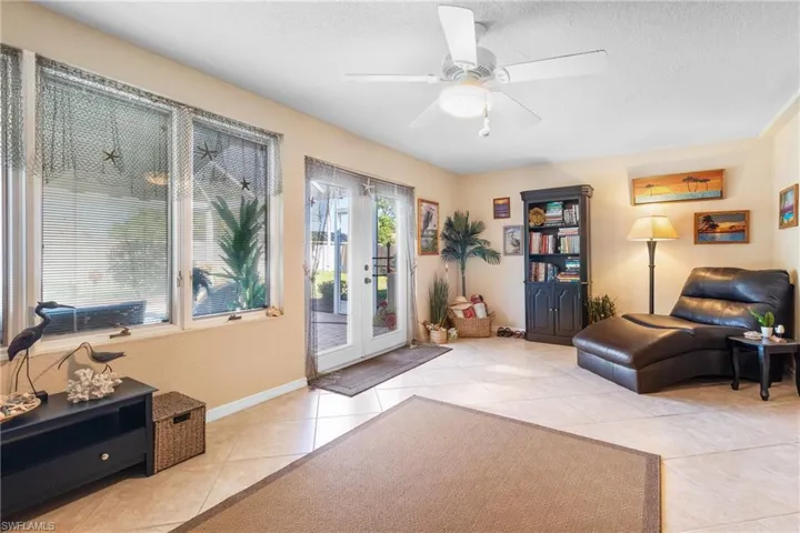 Sun Room with view of French doors to screened lanai,  and pool area