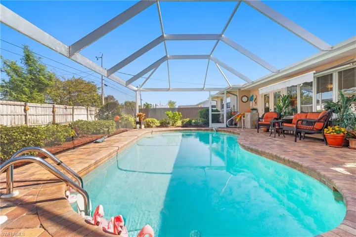 View of swimming pool featuring a lanai, outdoor lounge area, and a patio area