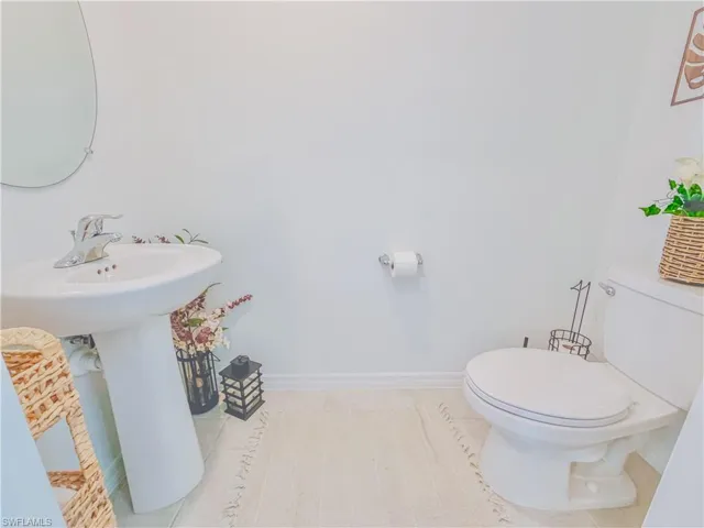 Half bathroom featuring baseboards and tile patterned floors