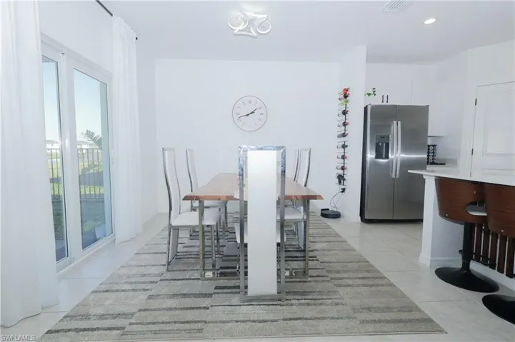 Dining space featuring recessed lighting and light tile patterned floors