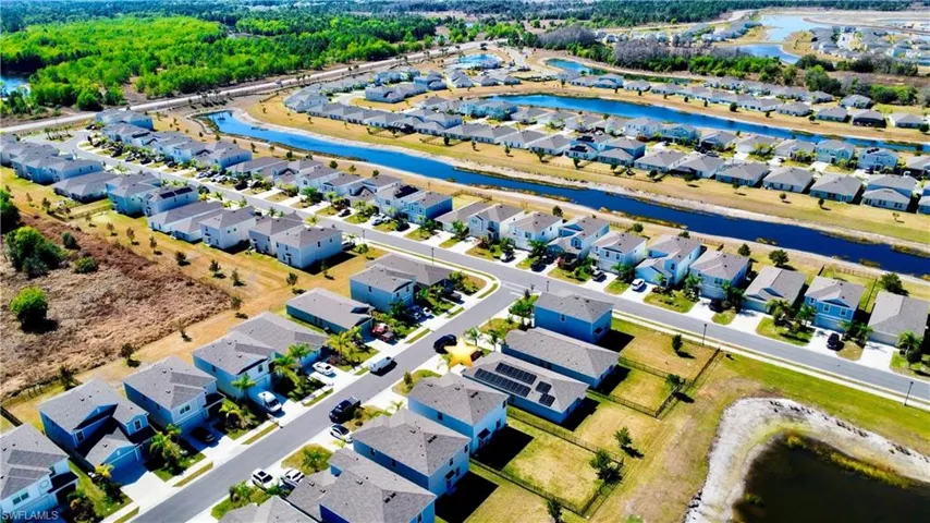 View of property location with a nearby body of water and nearby suburban area