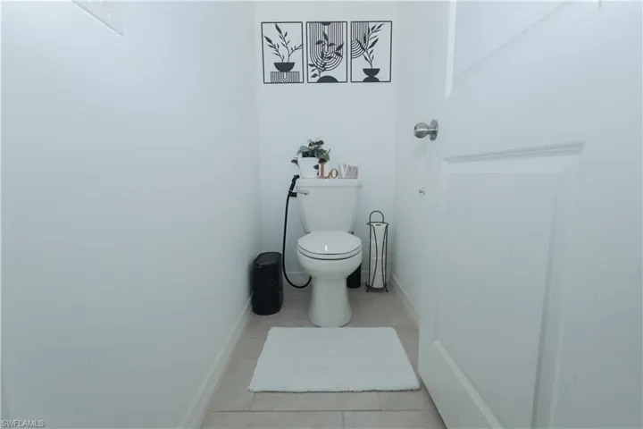 Bathroom featuring toilet and light tile patterned floors