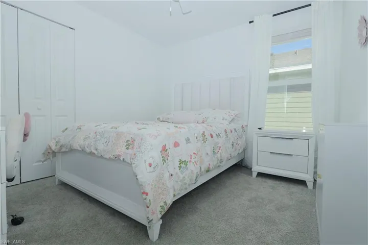 Carpeted bedroom featuring a closet