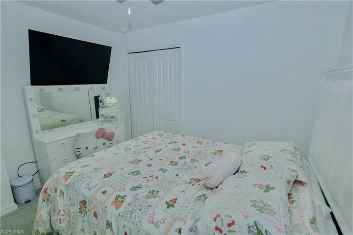 Bedroom featuring carpet flooring, a closet, and a ceiling fan