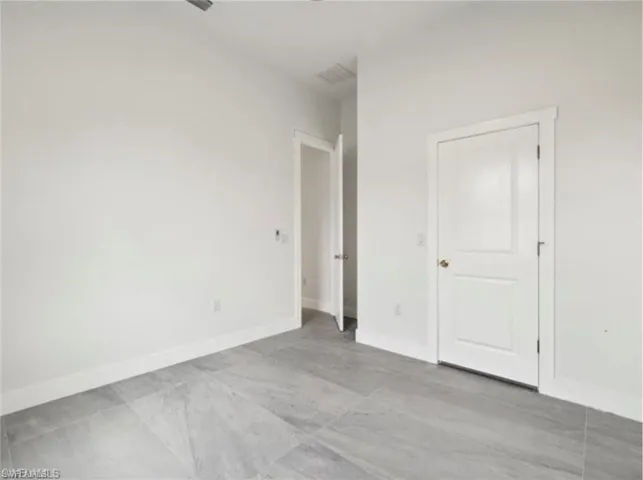 Empty room with baseboards and visible vents
