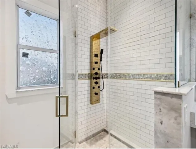 Full bathroom featuring plenty of natural light and a tile shower