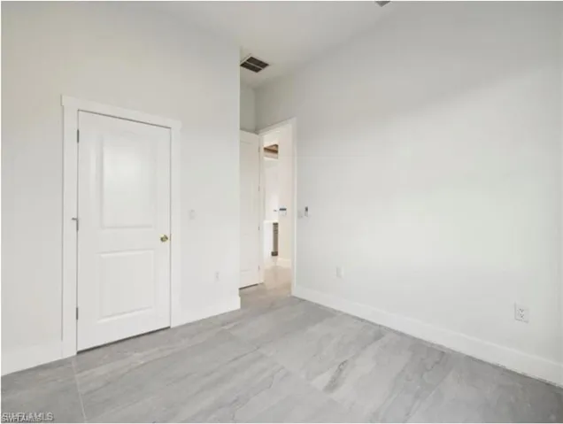 Unfurnished bedroom with visible vents and baseboards