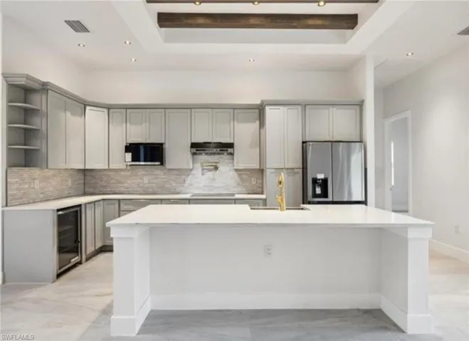 Kitchen featuring open shelves, black appliances, under cabinet range hood, gray cabinetry, and wine cooler