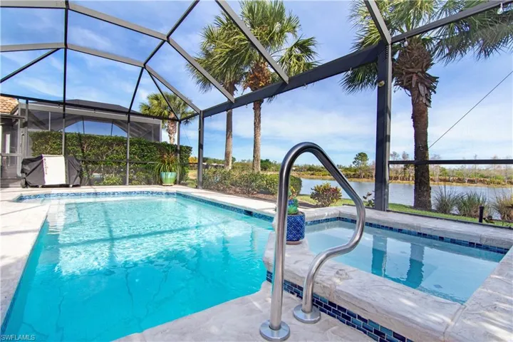 Pool with spa overlooking the water.