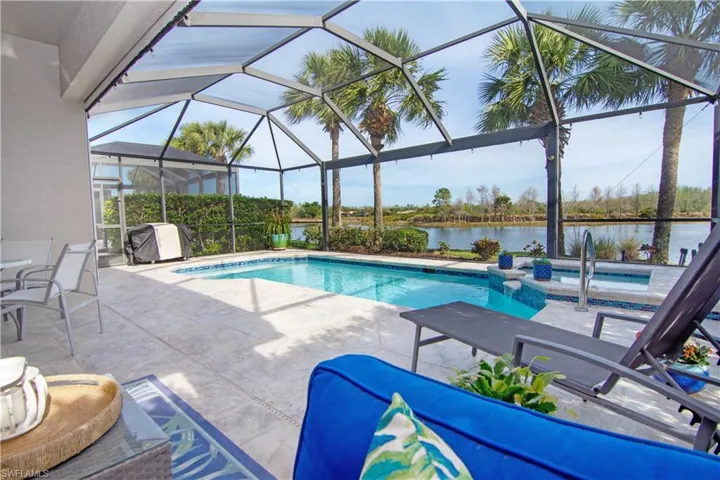 Relax by your beautiful swimming pool featuring a water view over to the golf course and wildlife preserve.