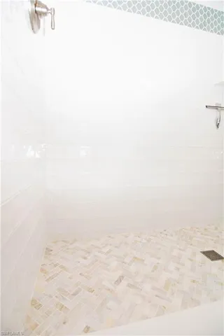 Carpeted bedroom with baseboards, visible vents, and a ceiling fan