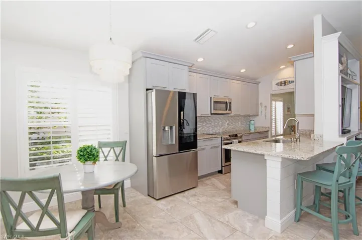 Enjoy casual dining at the breakfast table or granite bar with shiplap detail.