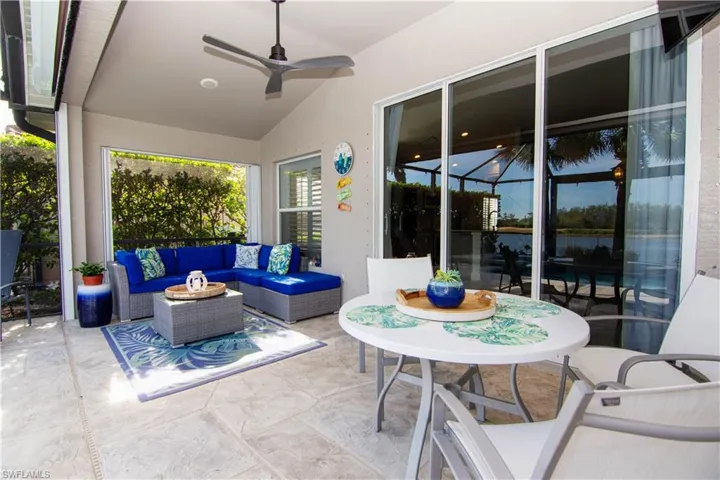 View of patio featuring a ceiling fan and an outdoor seating area.