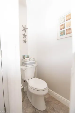 Water closet in primary bathroom features elongated taller toilet.