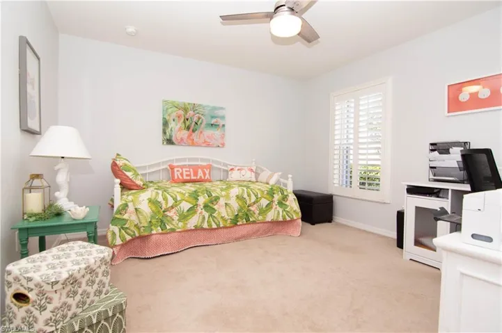 Carpeted bedroom with baseboards and ceiling fan