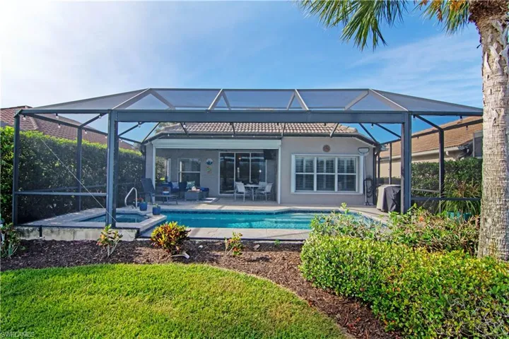 Rear view of property with screened lanai with picture frame window overlooking the lagoon.