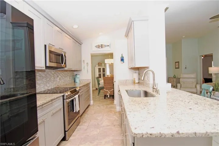Updated kitchen has a terrific layout and lots of cabinet and counter space as well as a pantry.