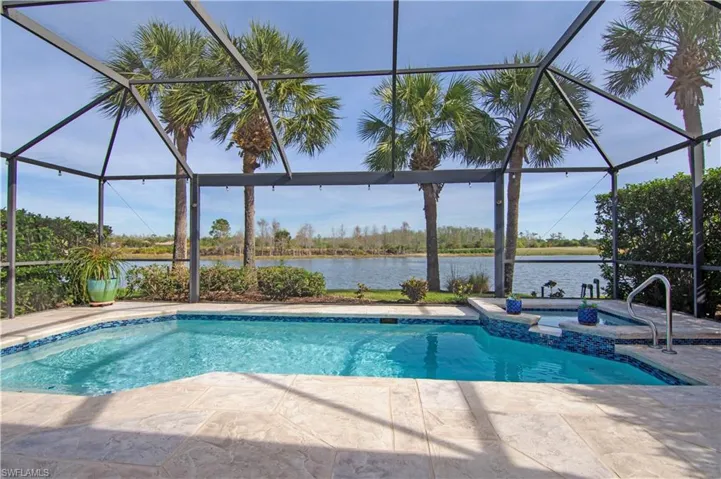 Screened lanai has a picture frame window that overlooks the lagoon and golf course with wildlife preserve in the background.