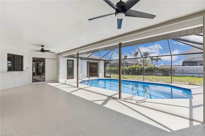 View of swimming pool featuring ceiling fan, a patio area, a lanai, and a fenced in pool