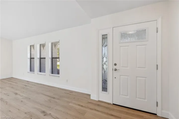 Foyer featuring light wood-type flooring and baseboards