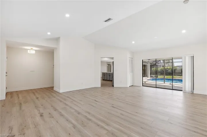 Unfurnished living room with light wood-style floors, recessed lighting, visible vents, and baseboards