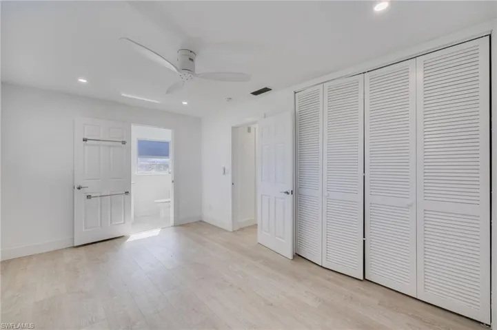 Unfurnished bedroom with recessed lighting, light wood finished floors, ceiling fan, and a closet