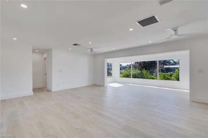 Spare room featuring a ceiling fan, light wood finished floors, and recessed lighting
