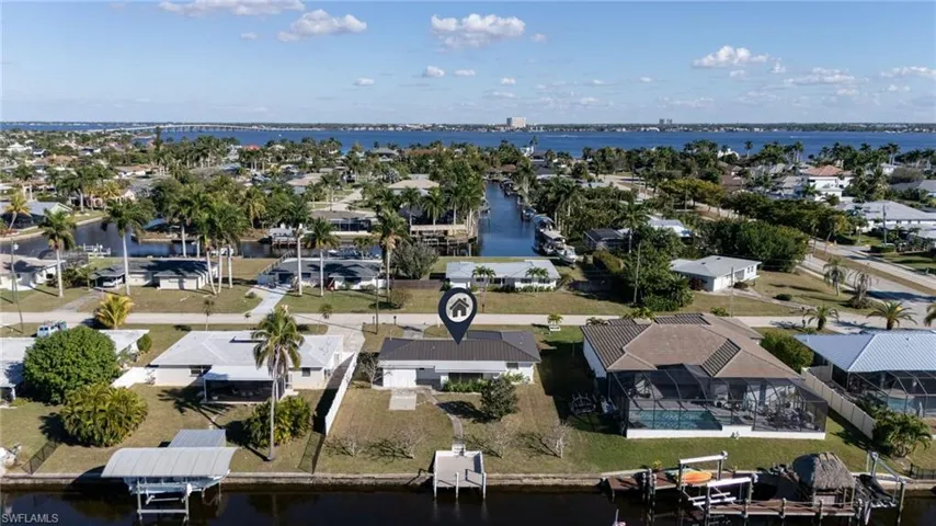 Aerial perspective of suburban area featuring a large body of water