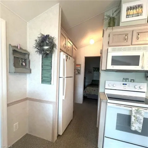 Cabinet pantry next to refridgerator