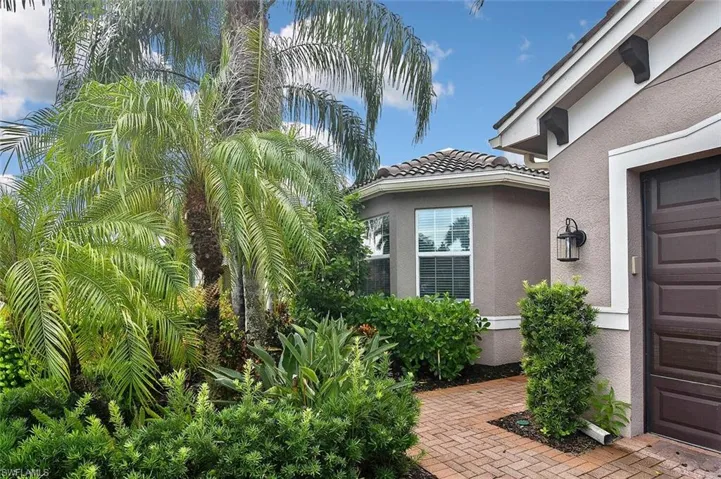 Lush landscaping in front and sides