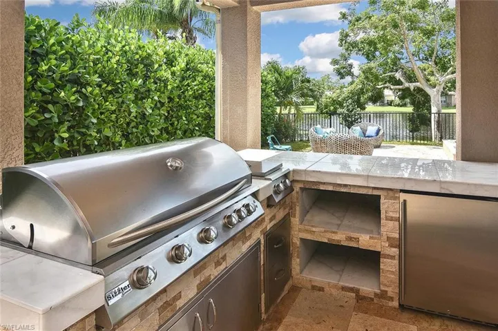 Outside kitchen including small refrigerator