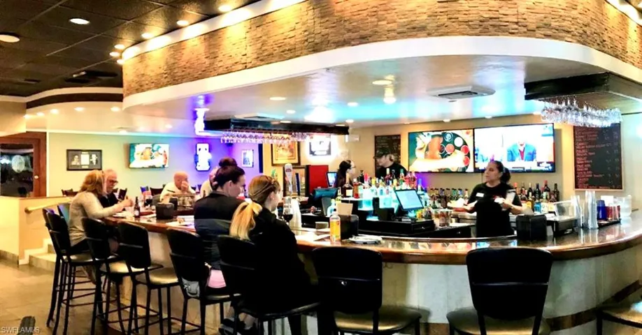 Curved bar with wood-finish countertop and contemporary bar stools