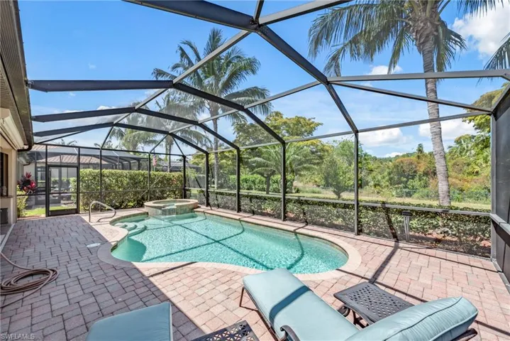 Pool cage with pool, spa and outdoor kitchen