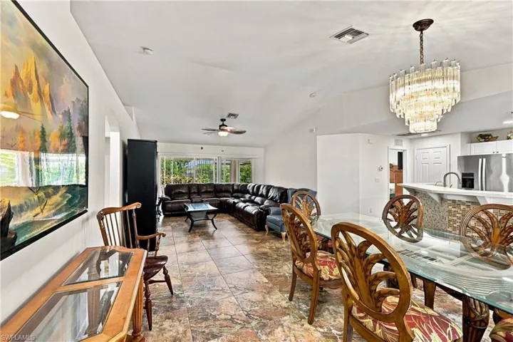 Vaulted ceilings enhance the main living areas, complemented by tiled flooring throughout