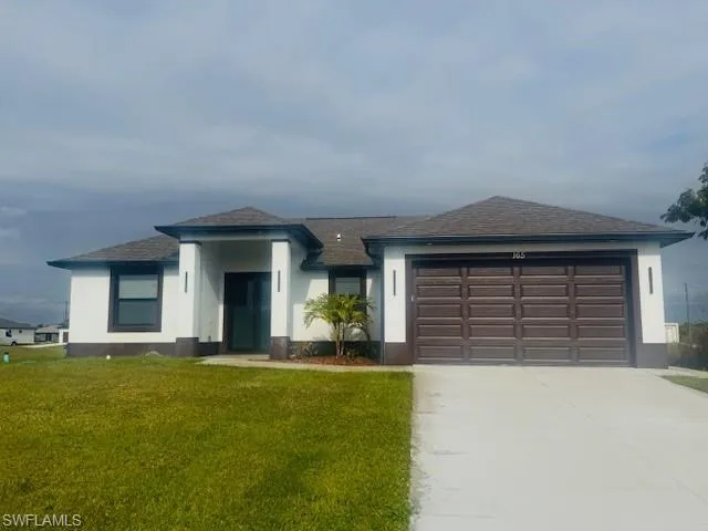 View of front of home with a front lawn, concrete driveway, an attached garage, roof with shingles, and stucco siding