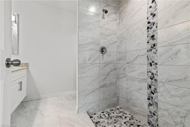 Features linen closet and dual sinks.