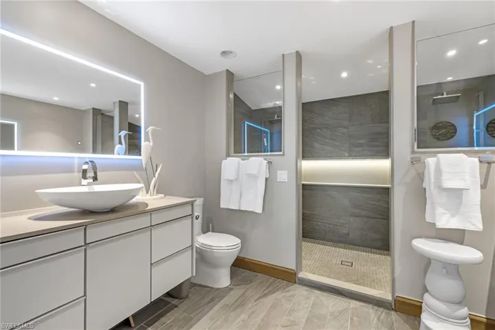 Primary Bathroom with Two Vanities and a Double Walk-in Shower w/ Two Shower Heads