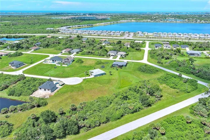 Aerial view of residential area featuring a large body of water