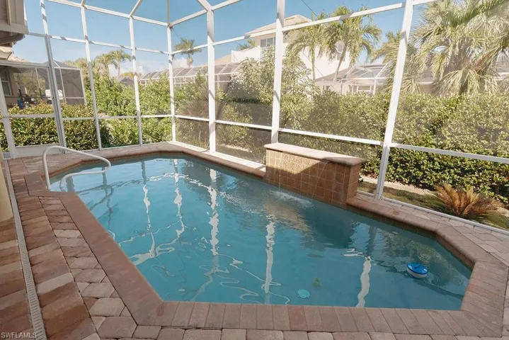 Heated pool on back paver patio with pool cage, uncovered to get sunlight