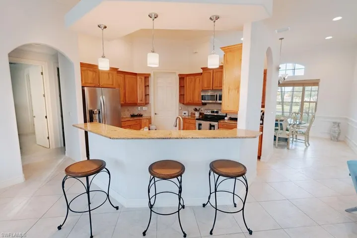 Kitchen with breakfast bar and arched walkways