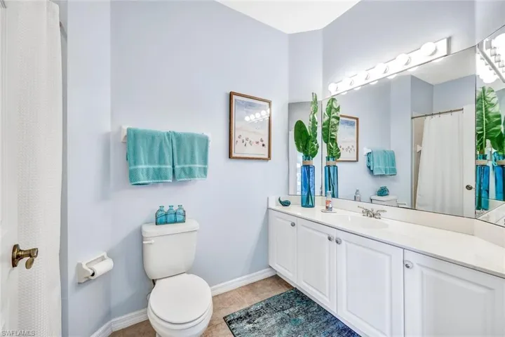 Bathroom featuring vanity, toilet, and tile patterned floors
