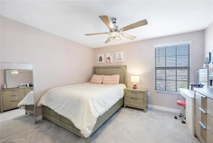 Carpeted bedroom with ceiling fan