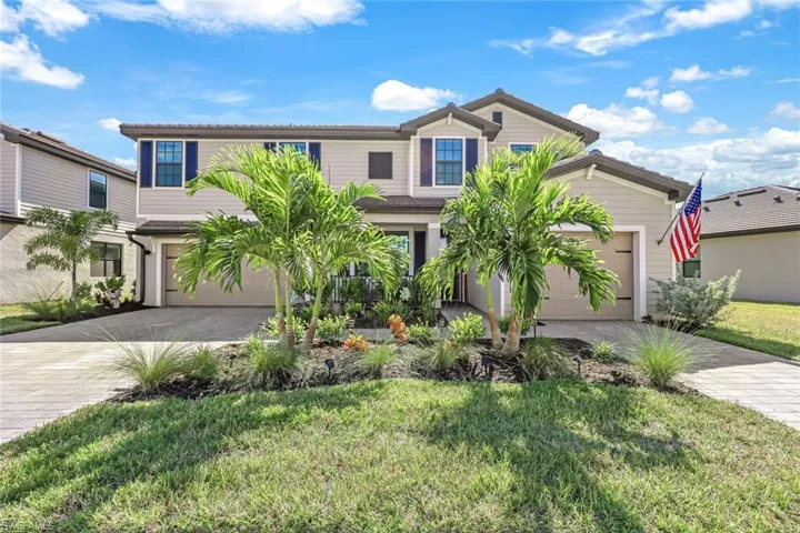 View of front of home featuring a garage and a front lawn